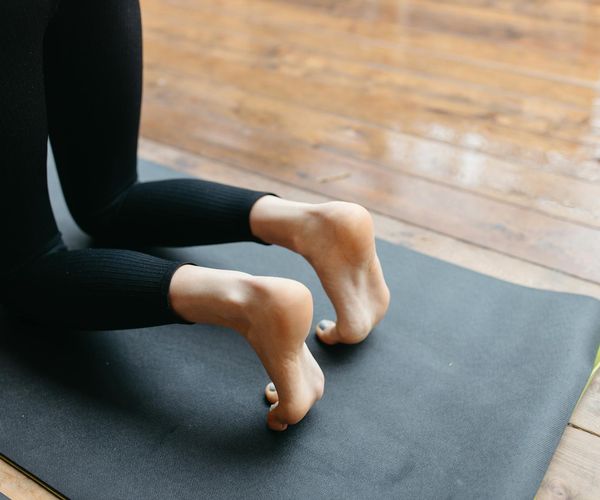 Person holding a yoga block, showing focus and physical stability.
